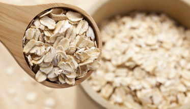 Healthy Dry Oatmeal in a wooden spoon