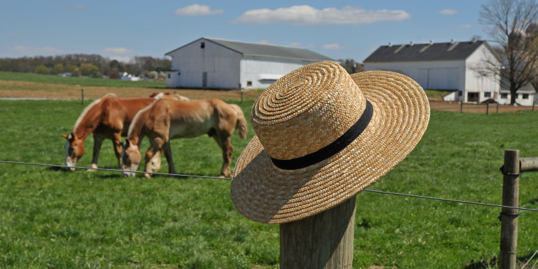 Amish hat on a farm fence post