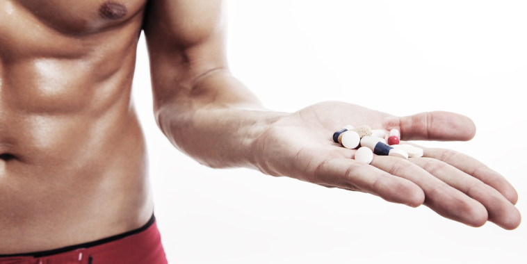 Muscular Male holding supplements