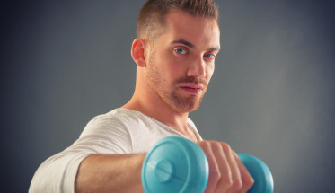 Handsome man holding dumb bells