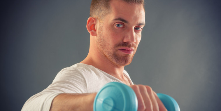 Handsome man holding dumb bells