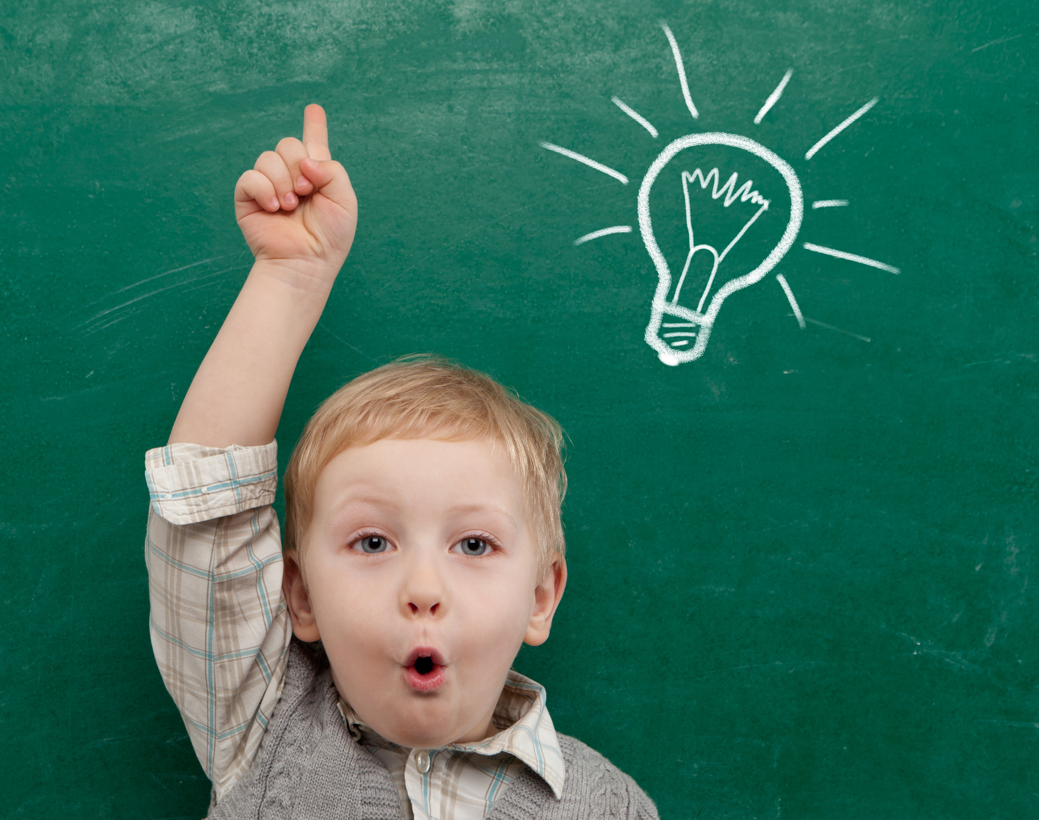 child pointing to light bulb