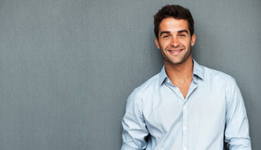 Handsome man leaning on wall