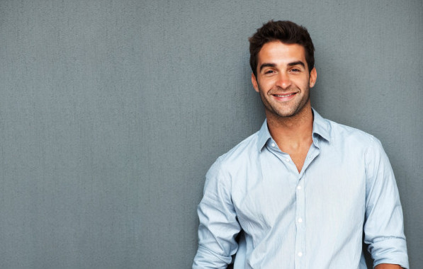 Handsome man leaning on wall