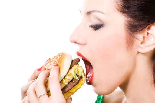 woman eating a hamburger